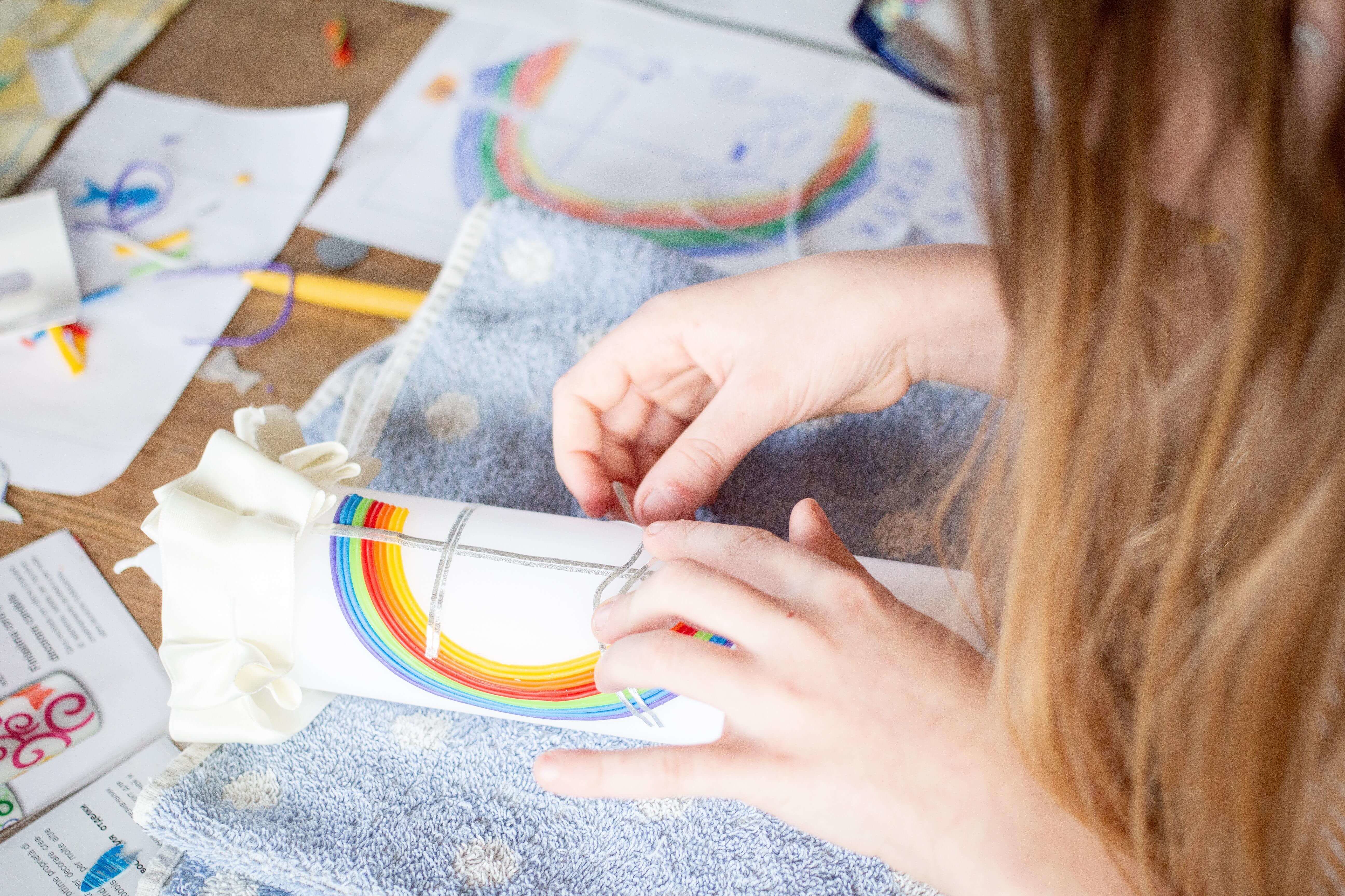 Child participating in a rainbow-themed creative therapy activity during a Melbourne child psychology session